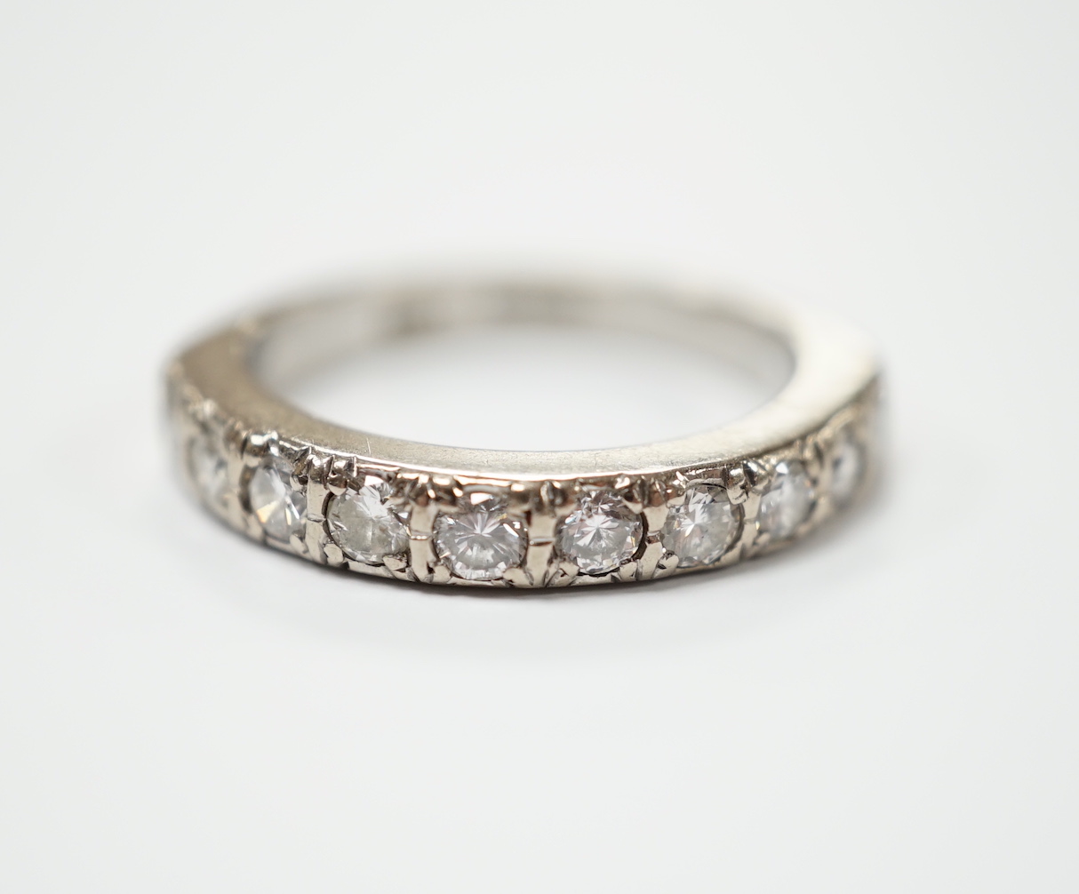A modern 18ct white gold and nine stone diamond set half eternity ring, size M, gross weight 5.3 grams.